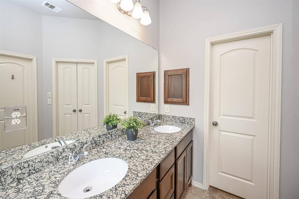 A stylish double vanity offers generous space for two, making busy mornings effortless. The sleek countertop provides ample room for daily essentials, while a convenient cabinet keeps personal items neatly tucked away