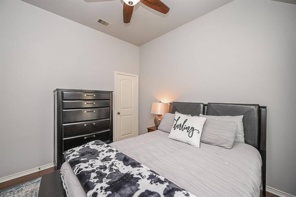 Ample room for furniture, beautiful floors, and a ceiling fan round out this wonderful secondary bedroom.