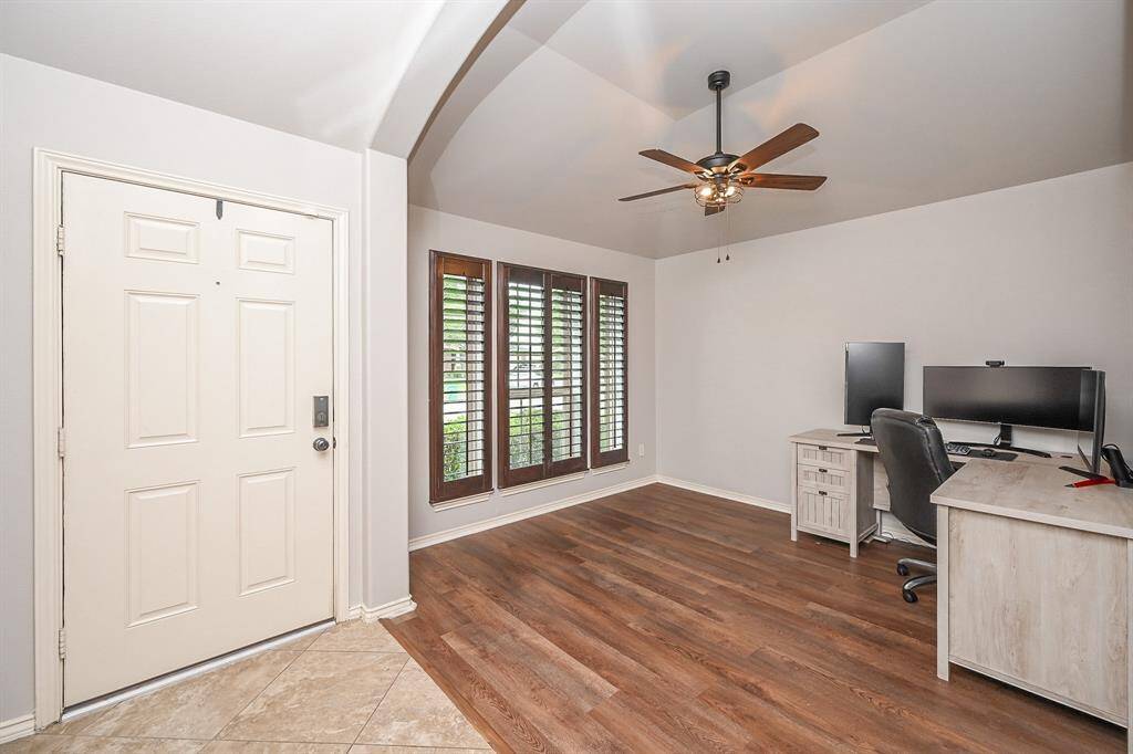 This charming brick home features a two-car garage and a well-maintained front yard with lush greenery and a paved driveway. The entrance is inviting, with a covered porch and attractive architectural details. Ideal for families seeking a cozy and welcoming space.