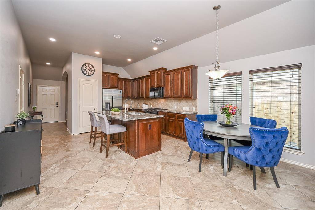 A large archway leads to the entry area in this versatile room currently used as a study. It could also be an extra TV room, living room, or game room.