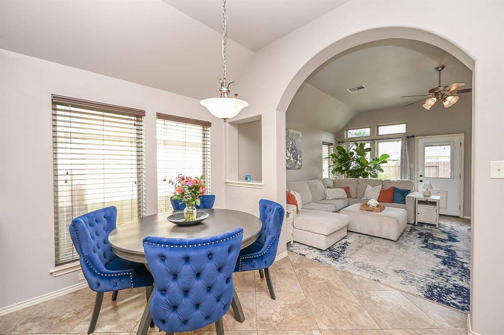 Open light and bright, yet warm and inviting, large windows and a beautiful architectural arch highlight the tall ceiling and 'entrance' to living.