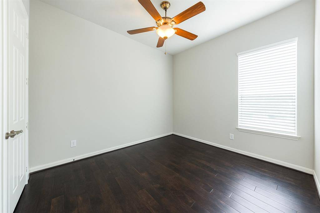 Secondary bedroom (guest room) provides the space you need for a large bed and any additional furnishings. Featuring a high ceiling, wood flooring, window with blinds and en-suite bath. This would be a great in-law suite also.
