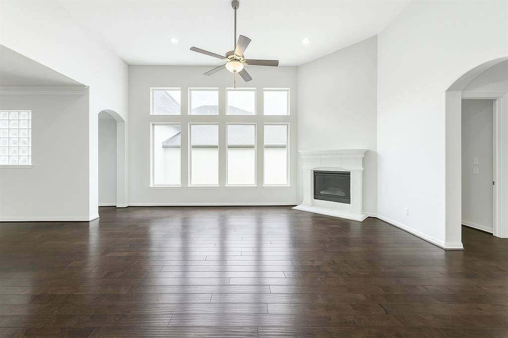 This sensational family room offers wood flooring, a high ceiling, fireplace and provides an inviting gathering place for family and friends!