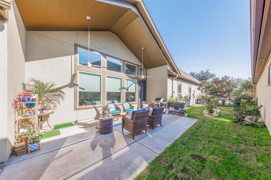 The side yard of this fantastic home includes a covered patio with ceiling fans, extended patio and landscaping. This area is the perfect place for outdoor cookouts with family and friends or a great place to relax at the end of the day!