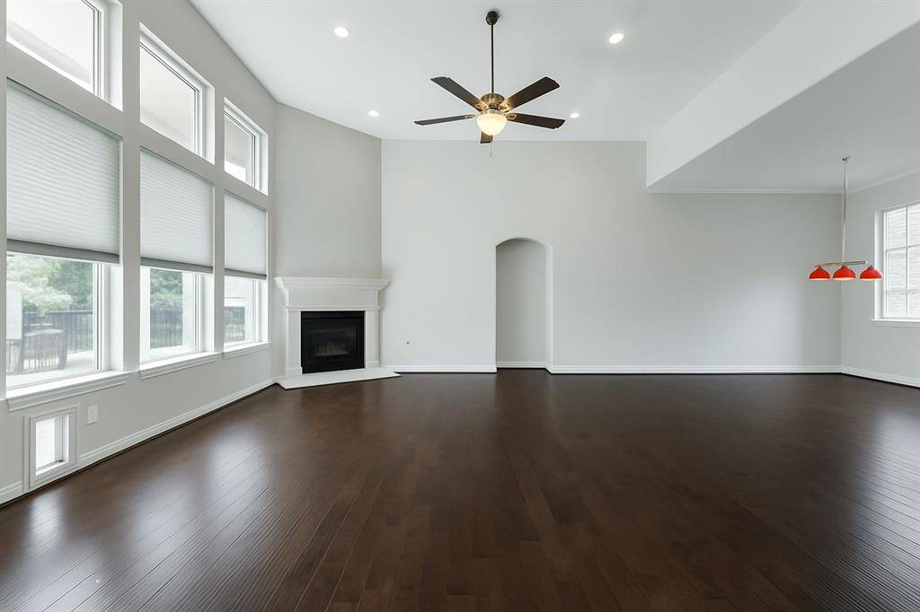 This sensational family room boasts wood flooring, a high angled ceiling, cozy fireplace and provides an inviting gathering place for family and friends! The open concept design shares space with the kitchen and breakfast area which is great for guests mingling.