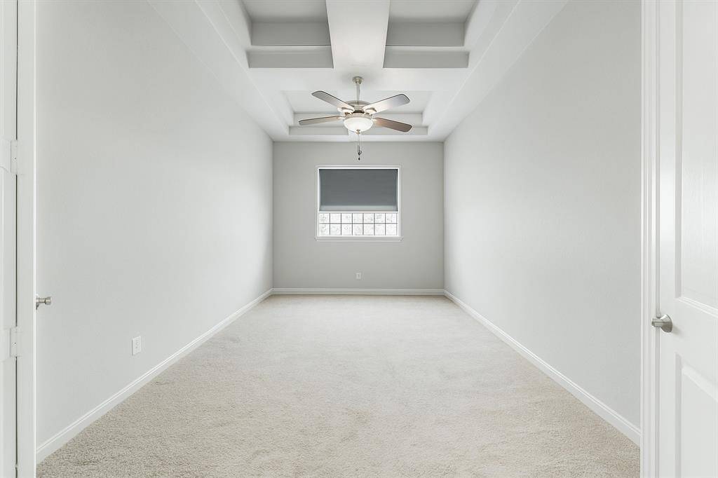 Need room to work at home? This spacious formal study provides the perfect place for that in-home office featuring double doors for privacy, high coffered ceiling, windows with custom blinds and room for a large desk, bookcases and accessories in a quiet environment. This room could be used as a game room or media room.