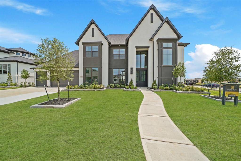 Remarkable elevation of the front of this VILLA MESSINA plan by FEDRICK HARRIS with stucco, an array of windows to let light flow in as well as gorgeous iron double front doors to welcome you in.