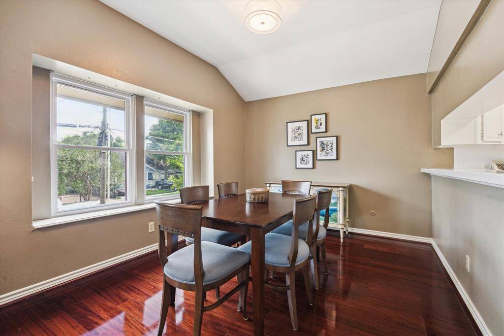 Front House: Dining area features warm brown walls and rich hardwood floors, with ample natural light from large windows.