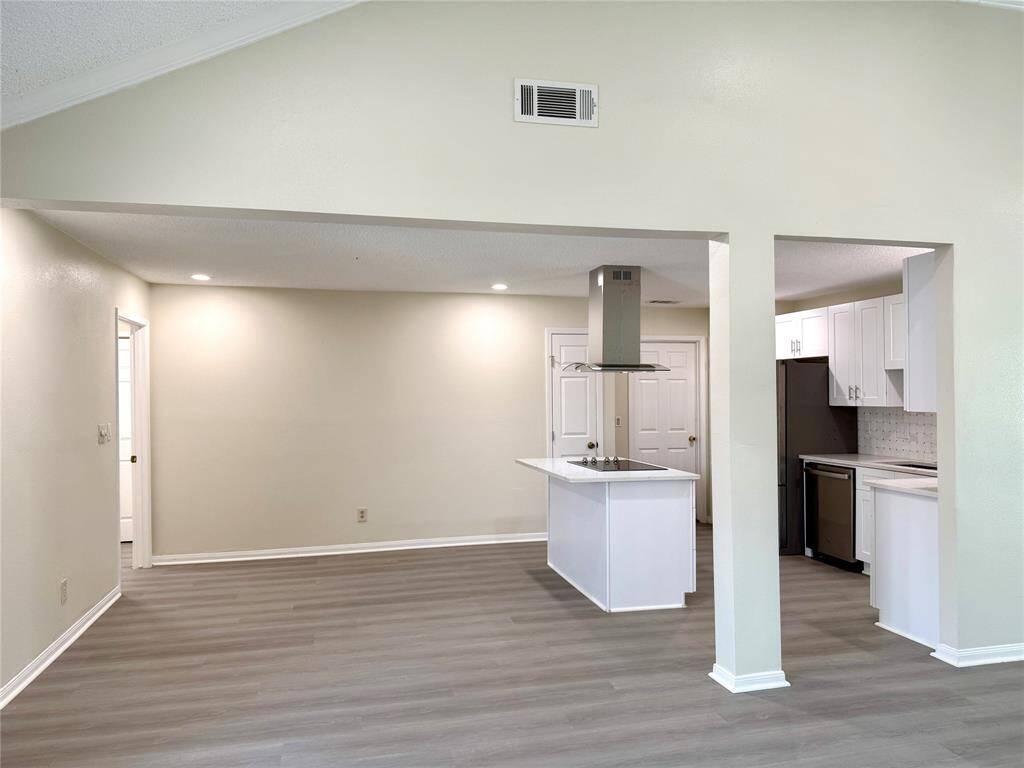 This home highlights an open floor plan where the living room flows effortlessly into the kitchen and dining area; the space offers a perfect blend of style and functionality.