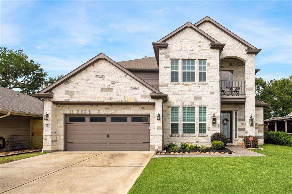 An elegant blend of traditional craftsmanship and modern design, this beautifully built two-story home makes a strong first impression with its light stone exterior, dark accents, and welcoming front entry. A covered balcony adds architectural interest, while lush landscaping and a wide driveway create a clean and inviting approach. The attached two-car garage and thoughtfully designed front elevation showcase both form and function in a peaceful residential setting.