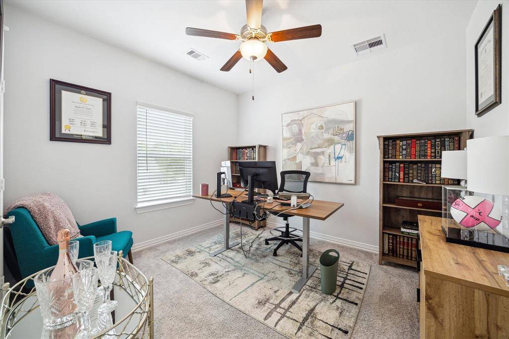 Comfort meets versatility in this generously sized secondary bedroom. Large windows allow for soft natural light, while neutral finishes and cozy carpet create a restful retreat. Whether used for sleep, study, or play, the layout easily adapts to suit a variety of needs.
