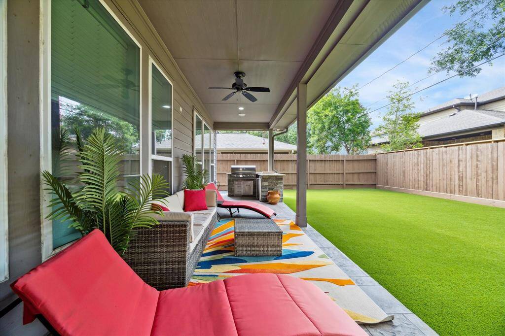 Step outside to a covered patio outfitted with ceiling fans, lounging space, and a built-in grill—perfect for al fresco dining or hosting weekend get-togethers. The expansive turfed backyard offers plenty of room to play without the upkeep, all enclosed by a privacy fence and bordered by mature trees.