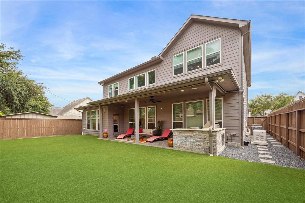 Backyard living is elevated with a wide covered patio, built-in grill station, and plenty of room to lounge or dine. The oversized yard is fully turfed for easy maintenance, and a side gravel path provides clean utility access. A private, fully fenced outdoor space that’s perfect for entertaining, play, or peaceful evenings at home. The home generator provides added peace of mind.