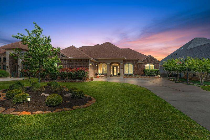 Welcome home to this gorgeous 1.5-story waterfront home at 11584 Grandview Drive in the gated community of Grand Harbor.