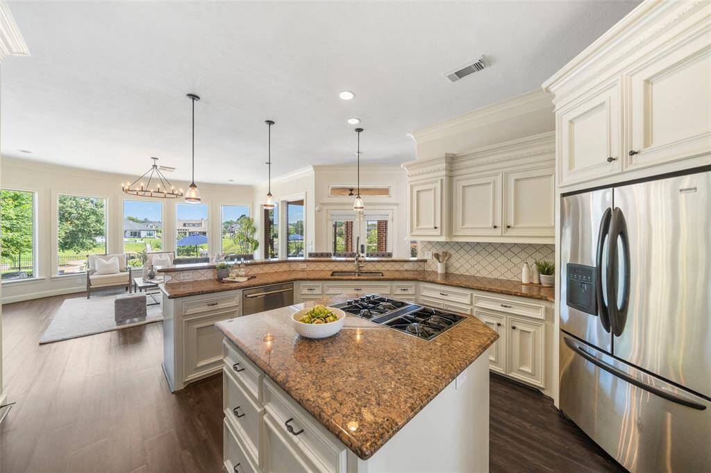 The main gathering area with gas cooktop looks into your gorgeous backyard.
