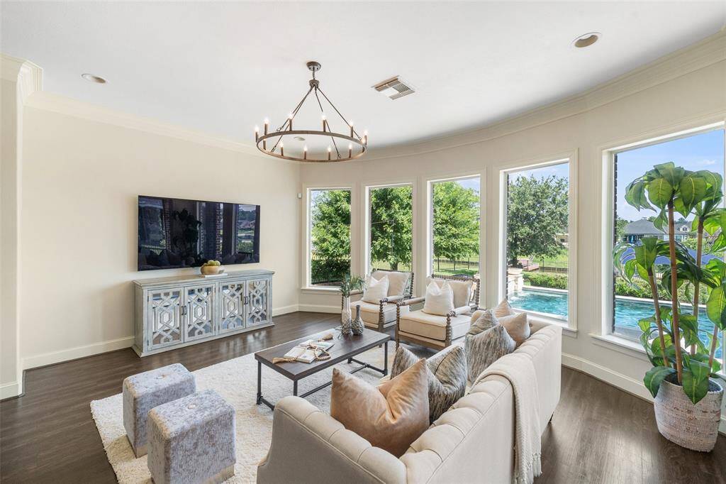 Spacious living area featuring stunning windows that showcase serene views of the backyard & down the canal.