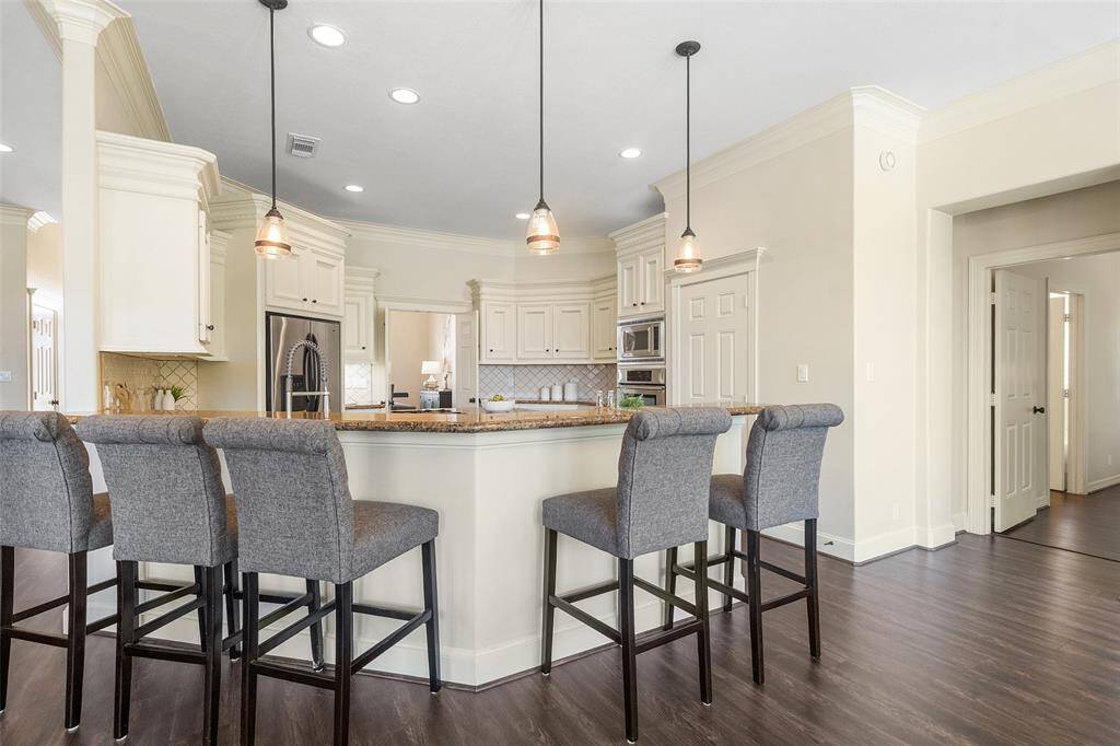 Another view into the kitchen with easy access to the huge walk-in pantry, plenty of bar seating for everyone.