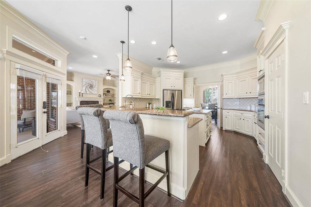 The kitchen features an open floor plan that seamlessly connects to the main living area, family room, and formal dining room—perfect for everyday living and effortless entertaining.