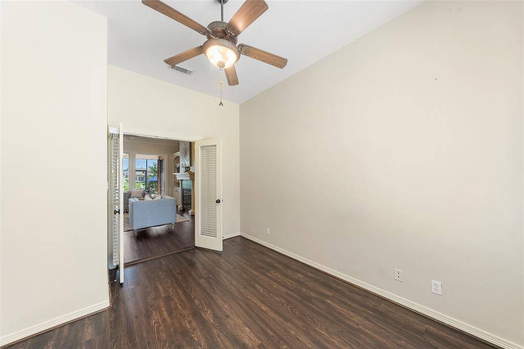 Office just off the entryway and formal living room, with custom blinds for privacy and a quiet space to work.