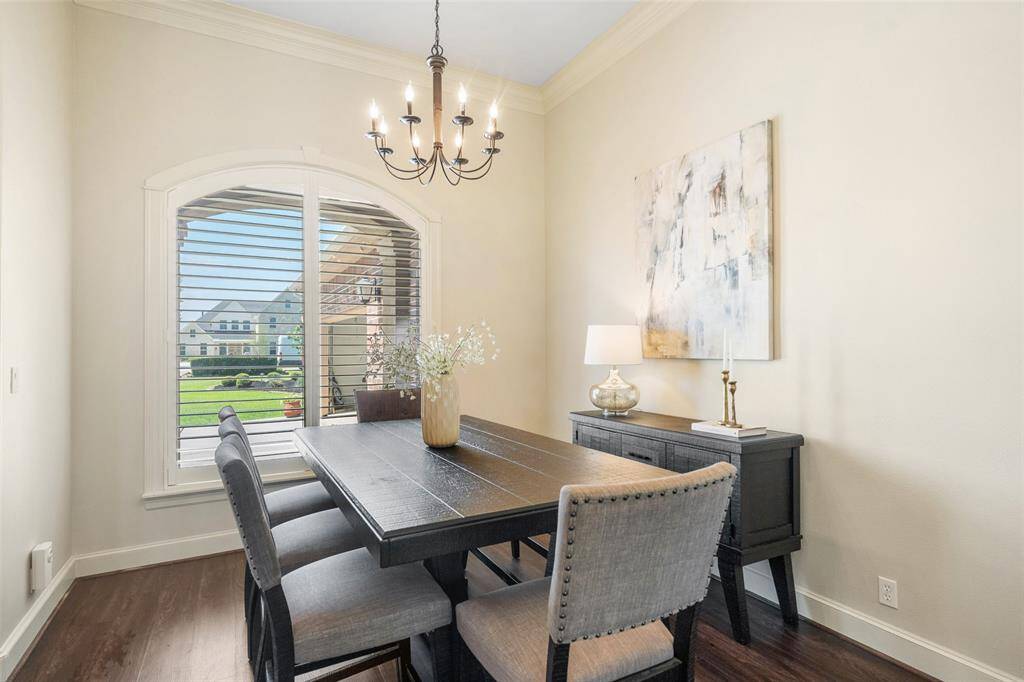 The large formal dining room with elevated ceiling offers plenty of room to host large gatherings and memorable dinners.