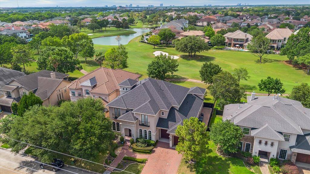 Welcome home to 11726 Montmarte! Aerial showcasing the golf course view of #15 fairway and lake.