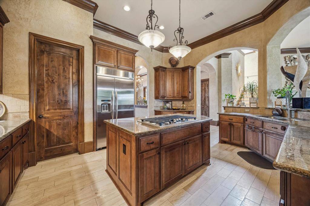 Stained interior doors, custom stained cabinetry, built in refrigerator and freezer, and large walk in pantry.