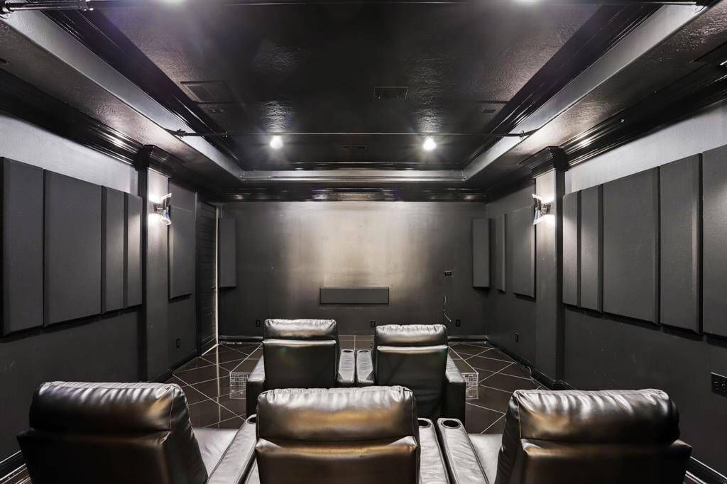 Second floor media room with acoustic paneling, theater seating and speakers. Secret room adjacent for storage, playroom, safe room, or studio to name a few.
