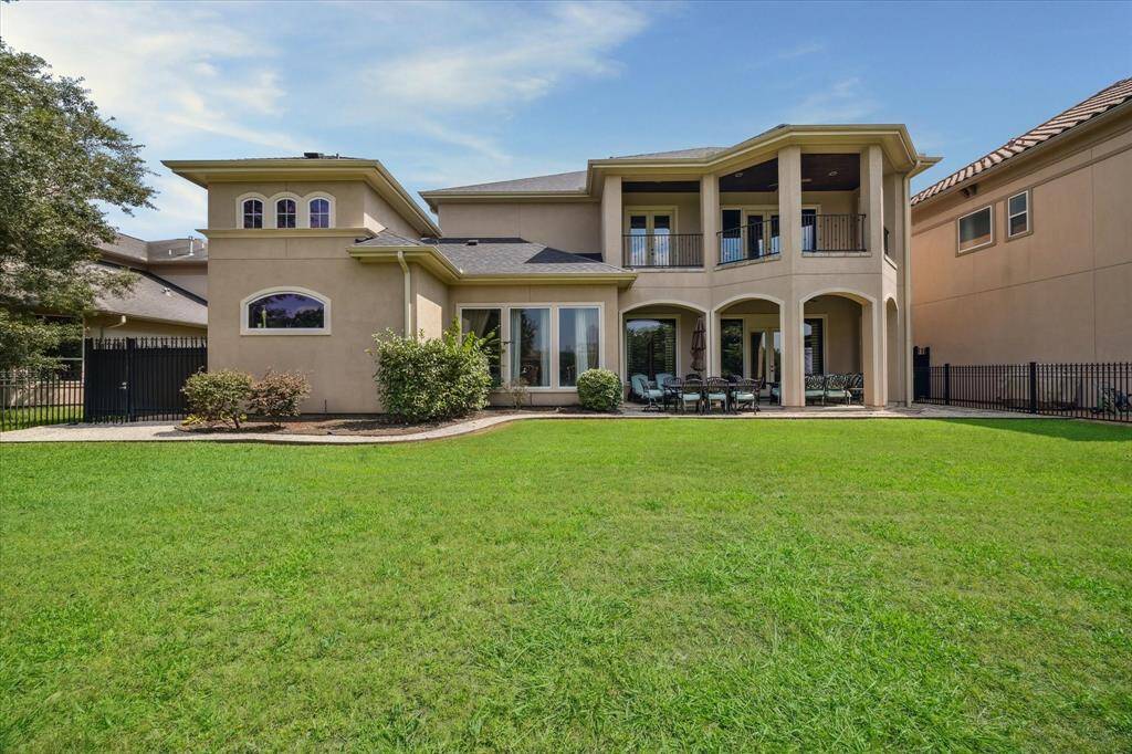 Mediterranean style exterior with windows across the back of the house to take advantage of the view.