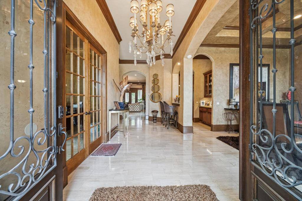 Formal entry open to the formal dining room and formal study. Skip trowel, faux finished walls and stained crown moulding and baseboards.