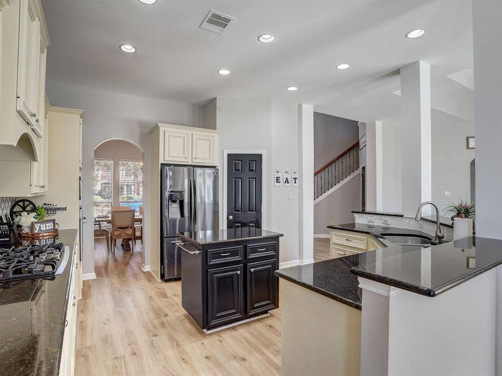 To the left, notice the gas cooktop! Preparing tasty meals with love added is what is on the menu.