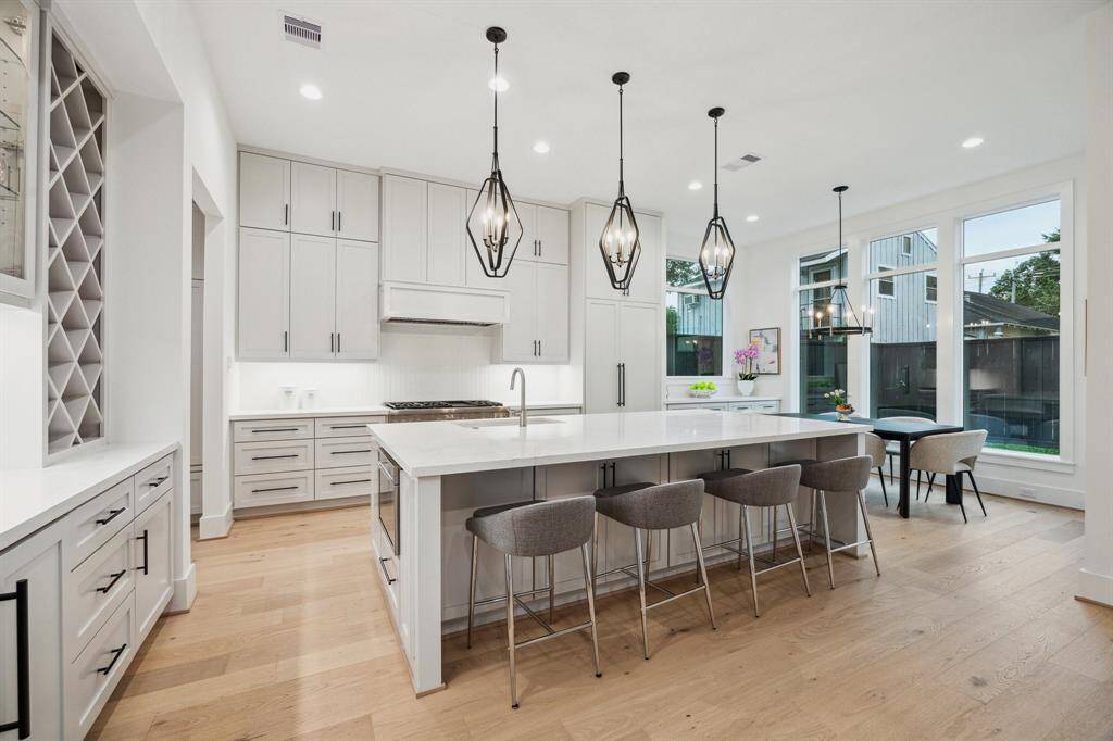 Island Kitchen with Breakfast Bar Seating, three 4 Light Pendants in a Sand Coal/Brushed Nickel Finish. There is an Incredible Appliance Package Including: Thermador Slide-In Range with 6 Burners, Griddle and Double Ovens. There is also a Hood with a Thermador Stainless Steel Liner, a Thermador Drawer Microwave, Thermador Panel Ready Built-In Dishwasher. Also included is a Thermador Panel Ready Refrigerator/Freezer.
