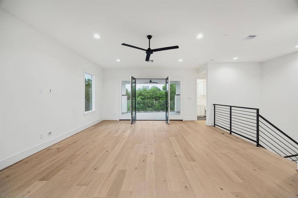Expansive (24' x 18'4") Game Room is Pre-Wired for Home Theatre (5 Speaker Locations and 1 Sub-Woofer),   MinkaAire 62" 3 Blade Ceiling Fan and Gorgeous Floors.  There is access to the Roof-Top Terrace plus there is a Full Bathroom so this area can be used as a guest suite or a bedroom.