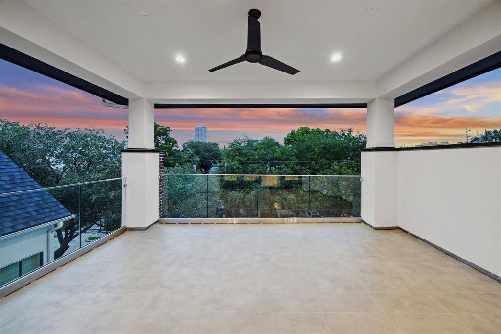 Covered Roof-Top Terrace with Westcoat ALX Waterproofing System with Decorative Overlay Finish.  There is a glass railing, on the north and west side of the terrace and a stucco wall on the east side.