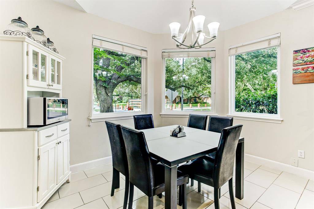 Amazing breakfast area overlooking beautiful trees through huge bay window.