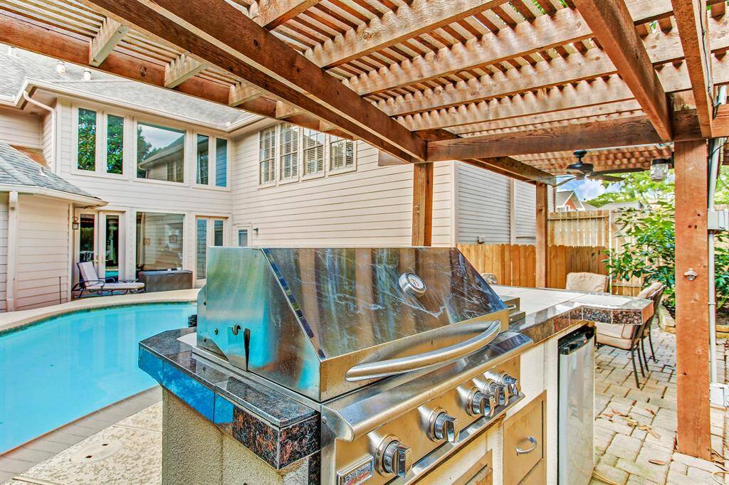 Paradise grill with granite countertops and built in refrigerator.  Great for entertaining outside under the gazebo.