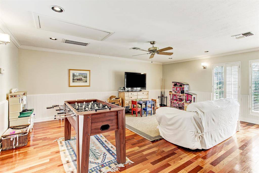 Playroom has lots of natural light with 8 large windows with plantation shutters.