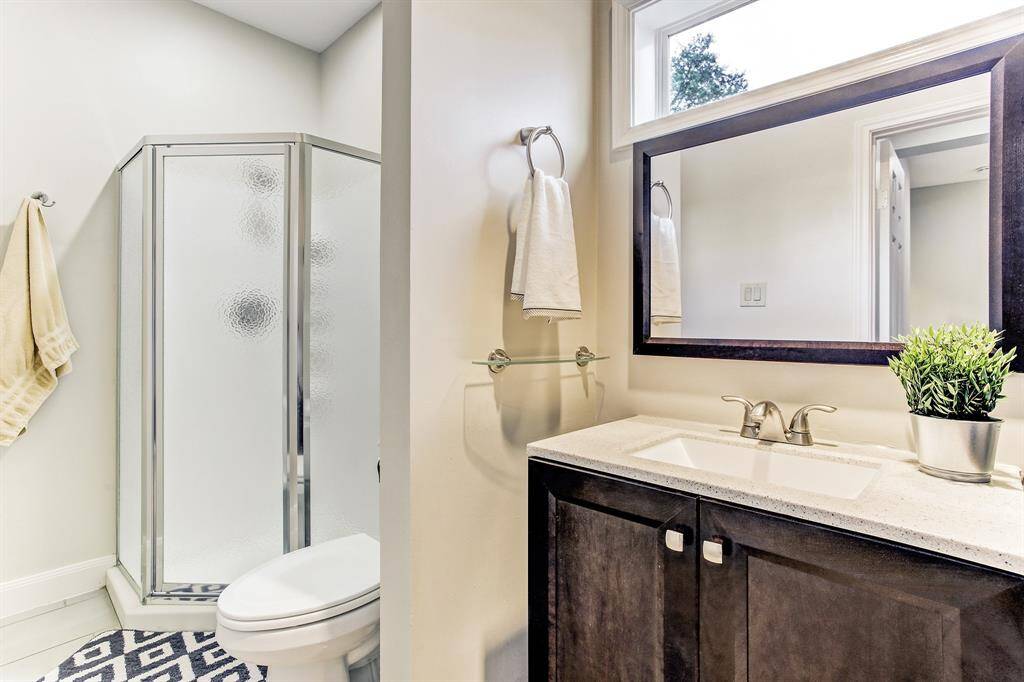Fourth bathroom near garage with direct access to pool.