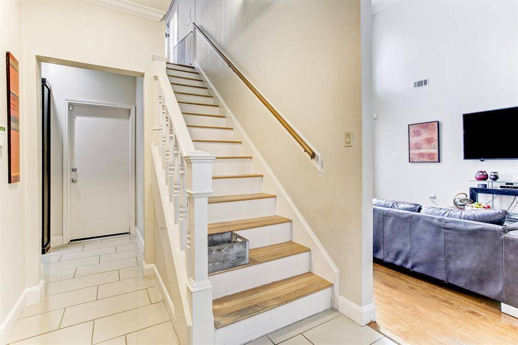 Hardwood staircase leading form kitchen to playroom.
