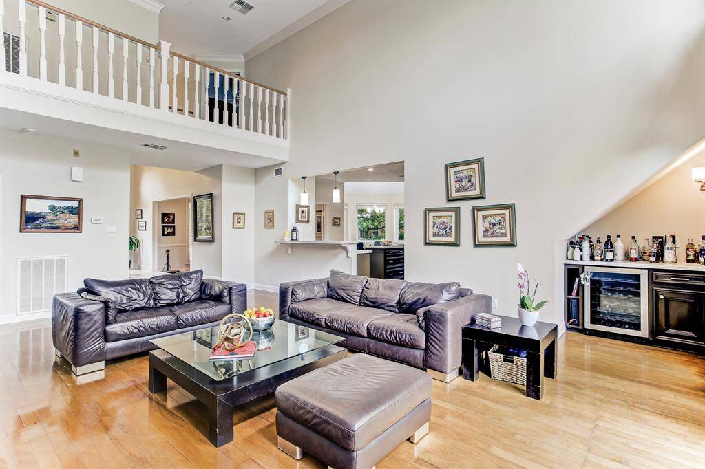 Living room with small mini bar under stairs with wine cooler.