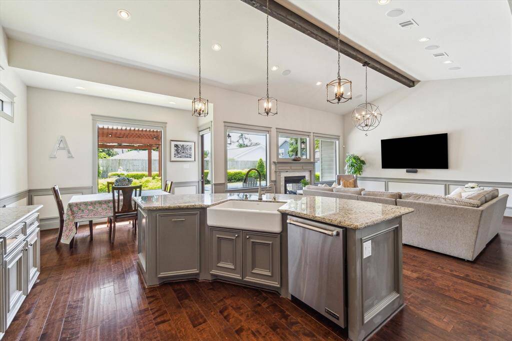 Large kitchen with island overlooking family room. Apron-front sink and Jenn-Air stainless appliances throughout