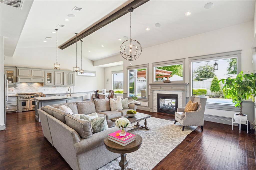 Light and bright family room and kitchen with hardwoods, recessed lights and chandeliers throughout
