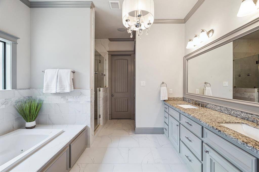 Large primary bathroom retreat contains soaking tub and large walk-in shower, double sinks and lots of storage