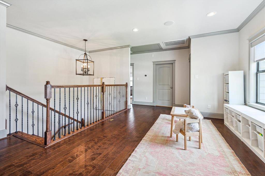 Just up the wooden staircase is a flex space - currently used as a play area