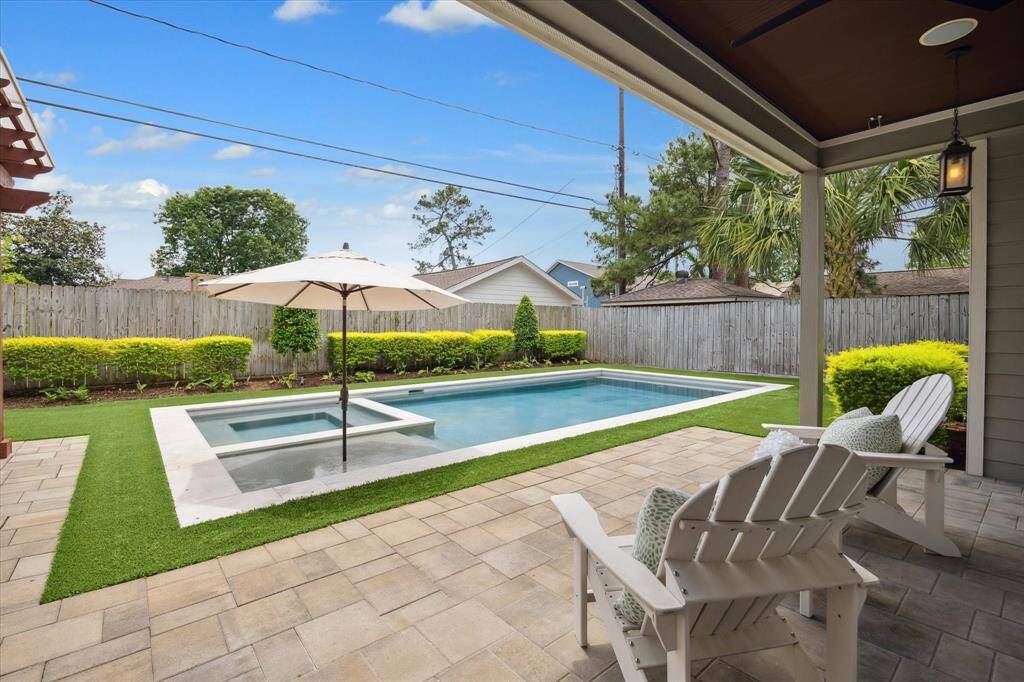 Backyard oasis features a recent pool, turf surround and 2 separate entertaining areas