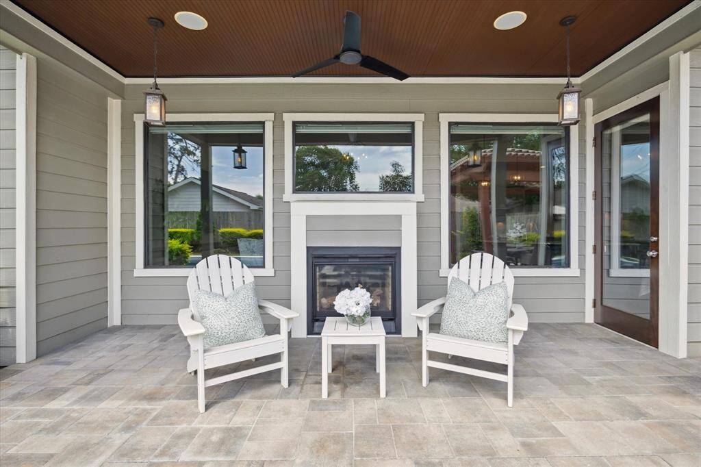 Lounge next to the double sided gas fireplace in this covered outdoor space