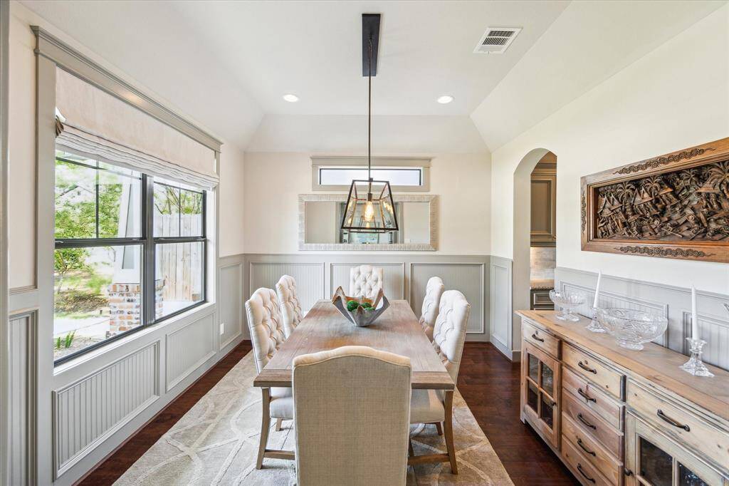 Spacious dining room with tons of natural light, wood floors and tall ceilings