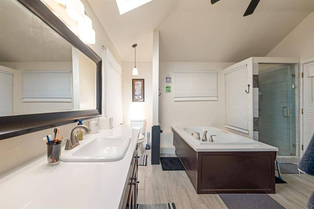 Primary bathroom with soaking tub and standing shower.