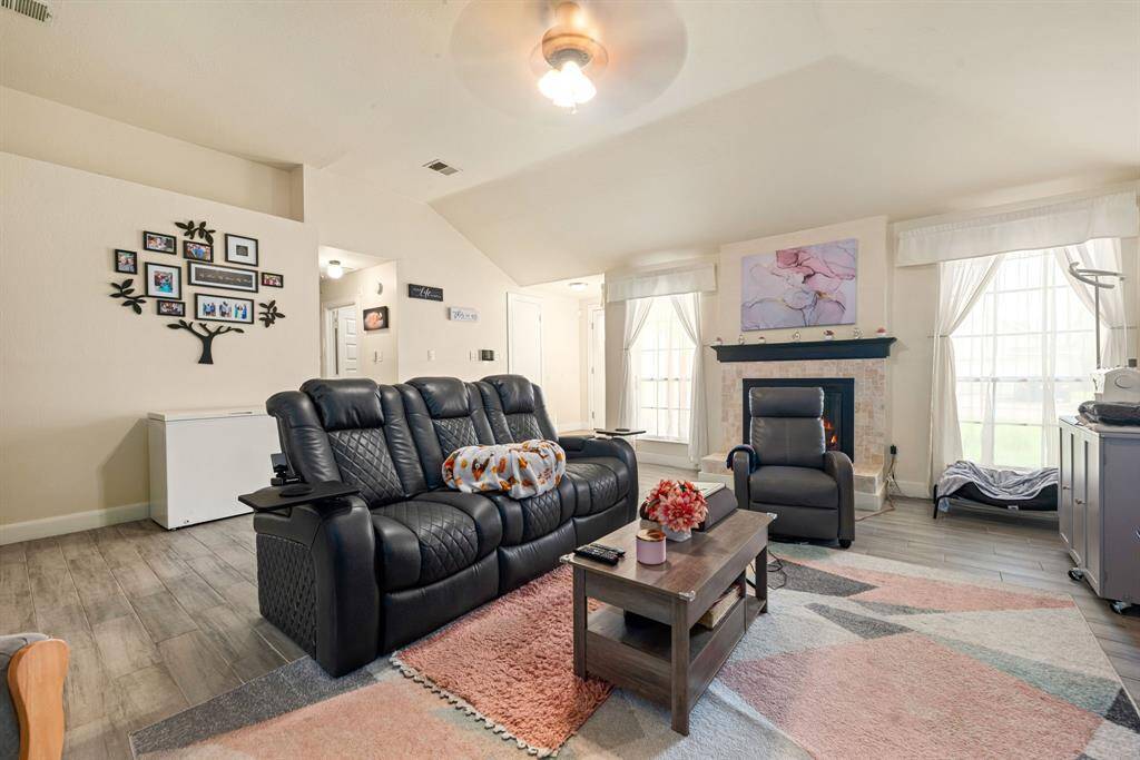 A cozy fireplace and large windows for natural light.