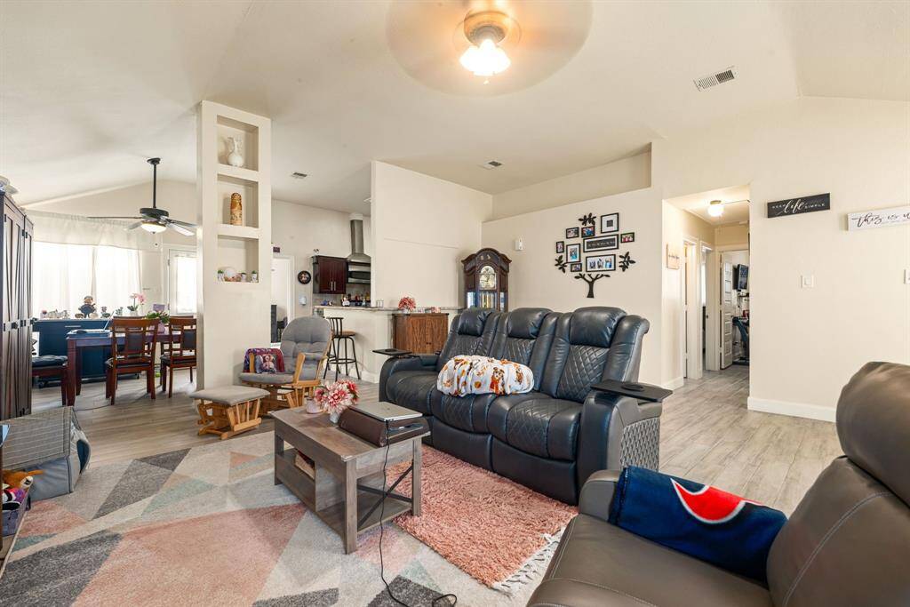 Living area with high ceilings, open layout, and seamless flow into the dining and kitchen spaces.