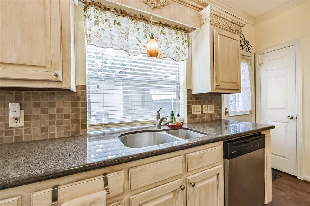 Do the dishes , while enjoying the beautiful view of the backyard and watch the kids play in the generous size backyard